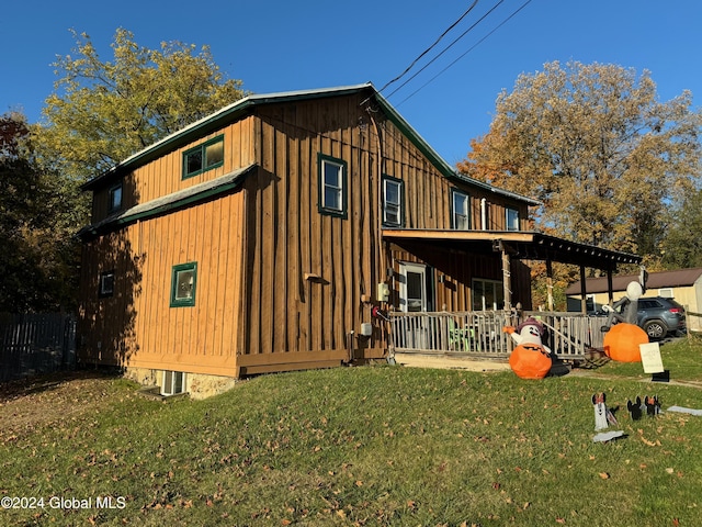 view of side of home featuring a yard and board and batten siding