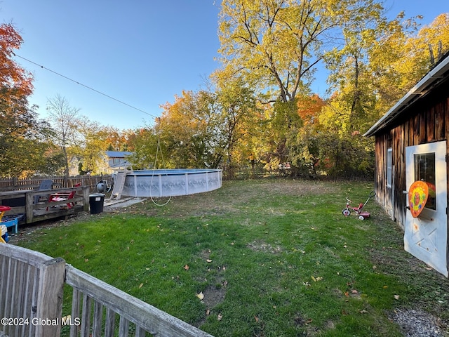 view of yard featuring an outdoor pool and a fenced backyard