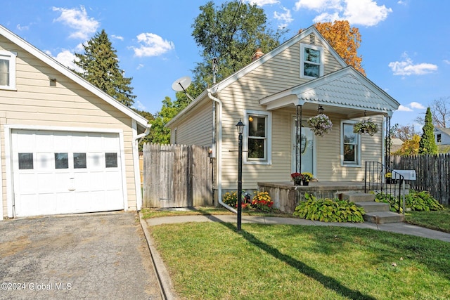 bungalow-style home featuring a front yard and a garage