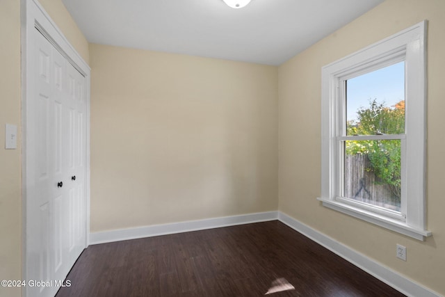 empty room with dark hardwood / wood-style floors