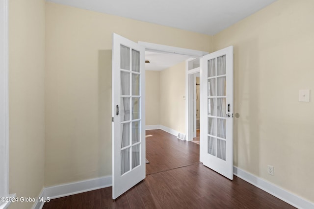 unfurnished room featuring french doors and dark hardwood / wood-style flooring