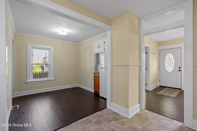 foyer entrance with ornamental molding and light wood-type flooring