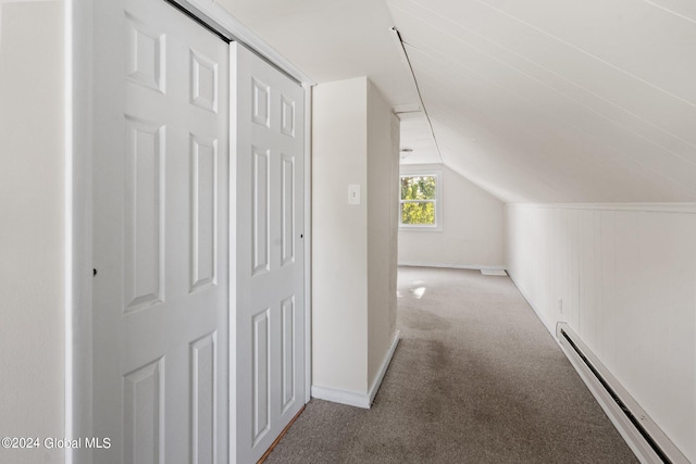 hall featuring vaulted ceiling, light carpet, and a baseboard radiator