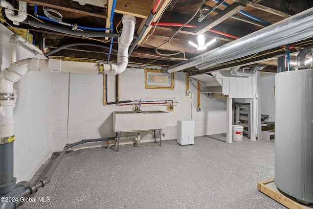 basement featuring sink and gas water heater