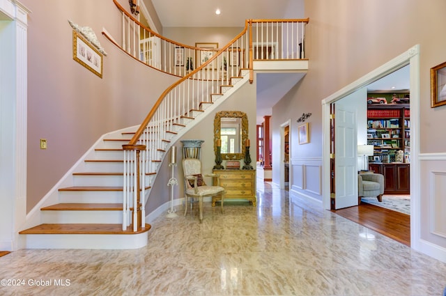 foyer entrance with a high ceiling and hardwood / wood-style floors