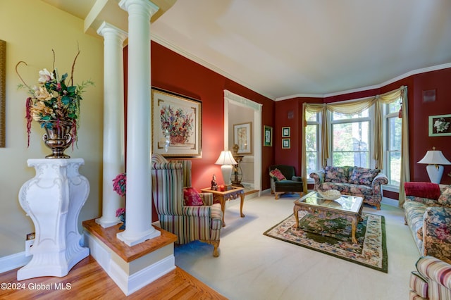 living room with ornamental molding, ornate columns, and hardwood / wood-style flooring