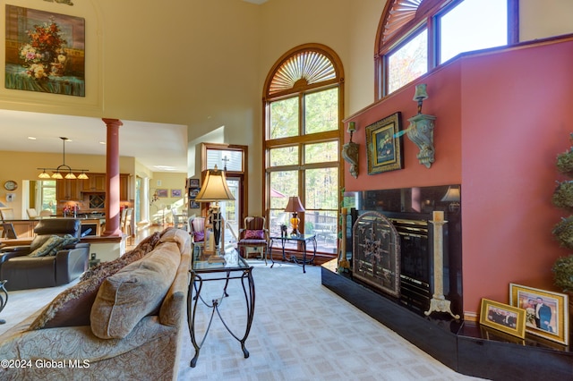 living room with a high ceiling and decorative columns