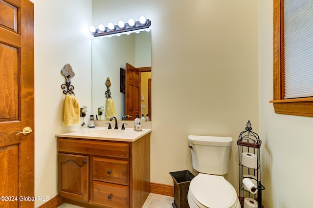 bathroom featuring vanity, toilet, and tile patterned floors