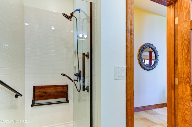 bathroom featuring a shower with door