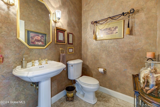 bathroom featuring toilet and tile patterned flooring