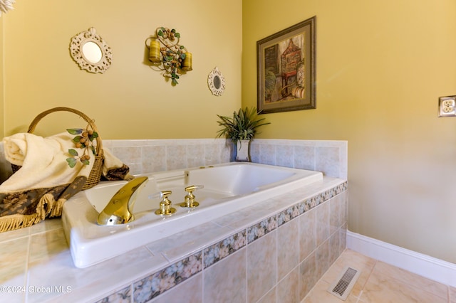 bathroom featuring tiled tub and tile patterned flooring