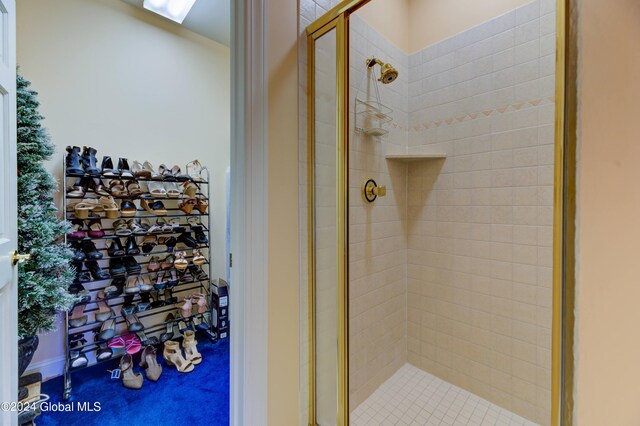 bathroom with a shower with door