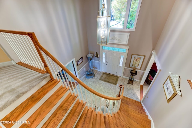 entryway with hardwood / wood-style floors and a chandelier