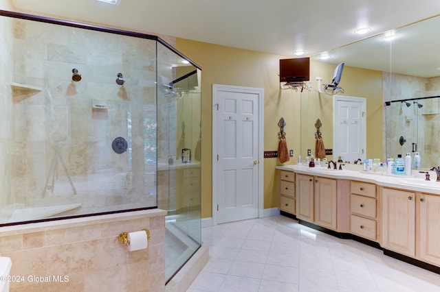 bathroom featuring vanity, a shower with shower door, and tile patterned flooring