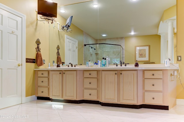 bathroom with vanity, an enclosed shower, tile patterned floors, and decorative columns