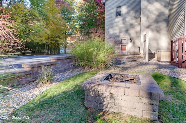 view of yard with a patio and an outdoor fire pit