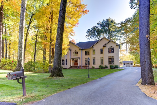 view of front of property featuring a garage and a front lawn