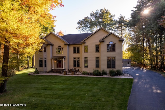 view of front of property with a front yard and a garage