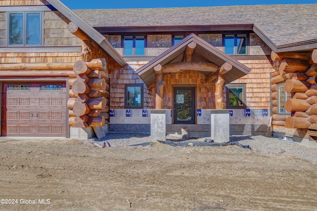 view of exterior entry featuring a garage