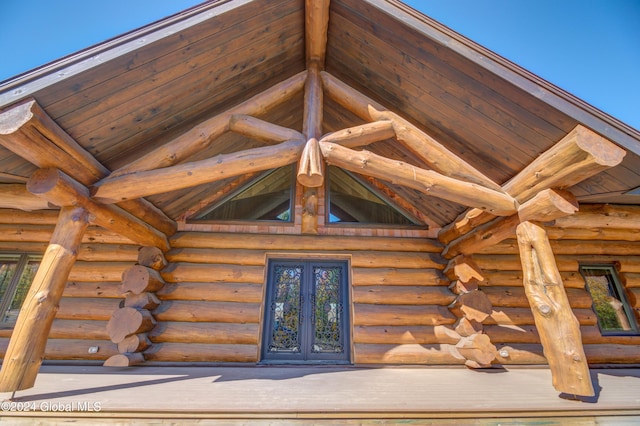 exterior space with rustic walls and wood ceiling