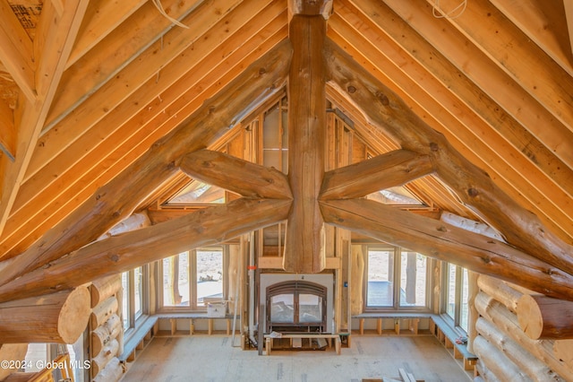 unfurnished living room with lofted ceiling and a healthy amount of sunlight