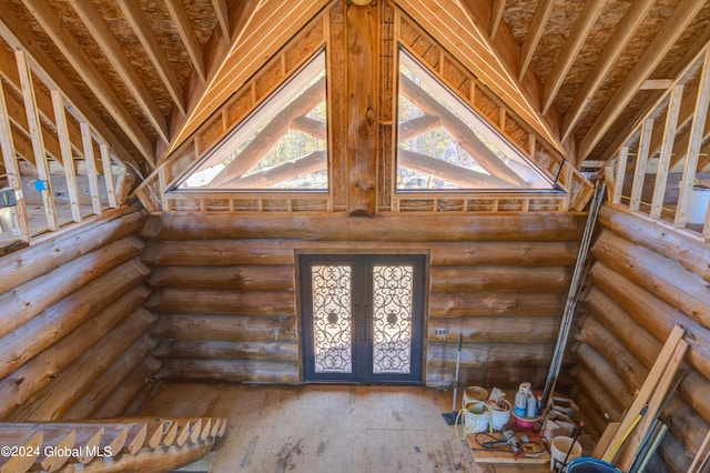 interior space featuring french doors and high vaulted ceiling