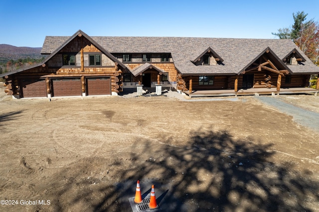 log-style house featuring a garage