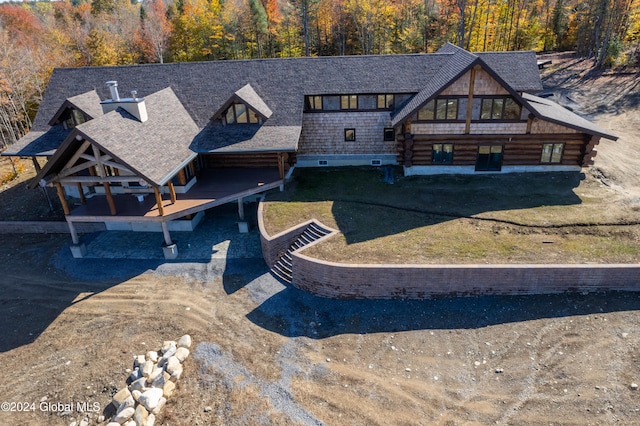 rear view of house featuring a yard