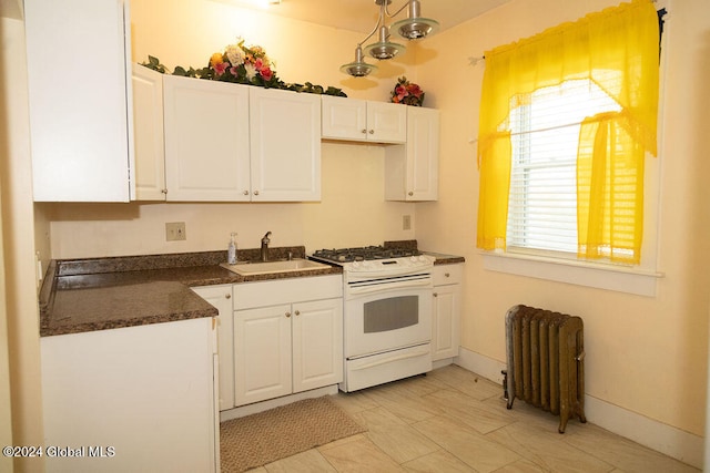 kitchen featuring white cabinetry, radiator heating unit, sink, and white range