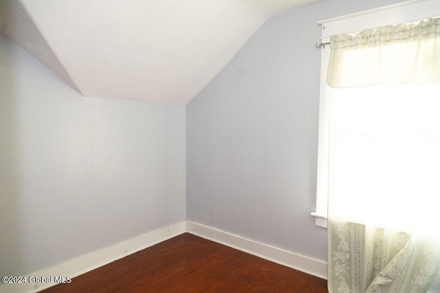 bonus room with vaulted ceiling and dark hardwood / wood-style floors