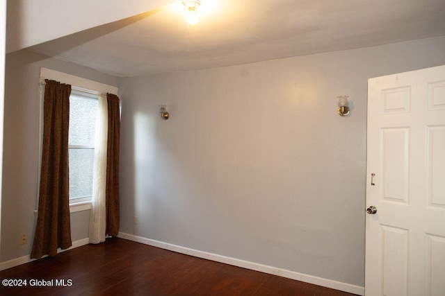 spare room with dark wood-type flooring