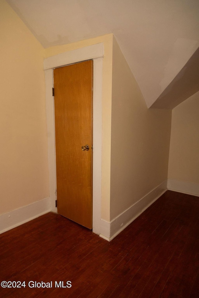 bonus room featuring wood finished floors, baseboards, and vaulted ceiling