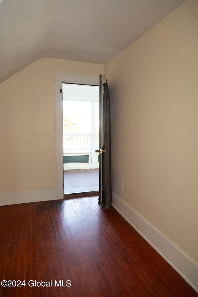 interior space featuring vaulted ceiling and dark hardwood / wood-style floors