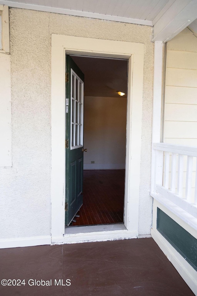 property entrance with stucco siding