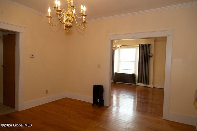 unfurnished room featuring ornamental molding, hardwood / wood-style flooring, and radiator heating unit