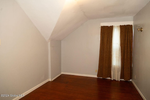 bonus room featuring dark hardwood / wood-style floors and vaulted ceiling