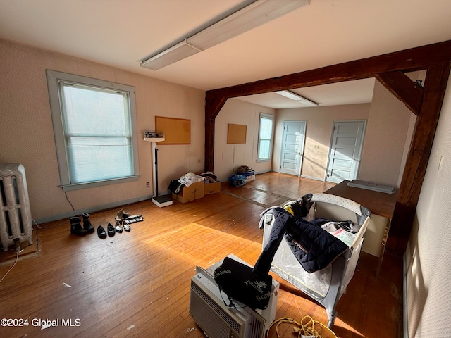 exercise room with radiator heating unit and wood-type flooring