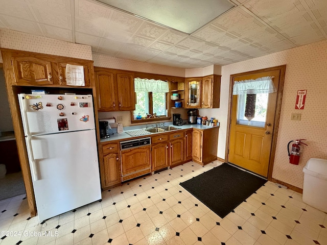 kitchen with dishwasher, white fridge, and sink