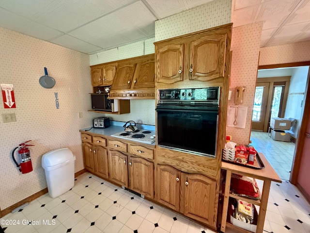 kitchen with black oven and white electric stovetop