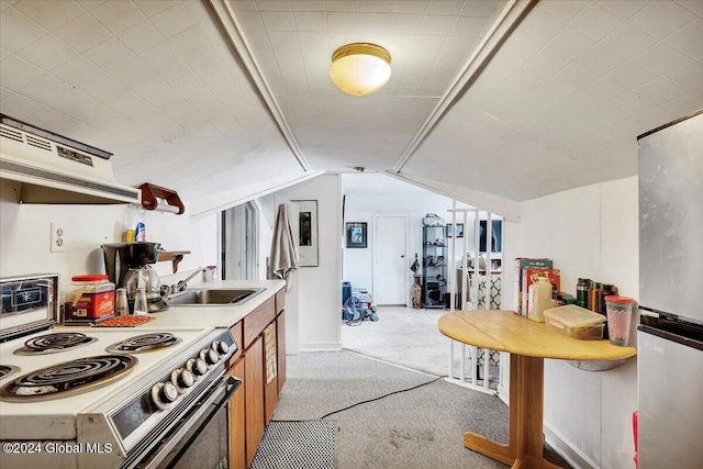 kitchen featuring light carpet, stainless steel fridge, vaulted ceiling, white range with electric stovetop, and sink