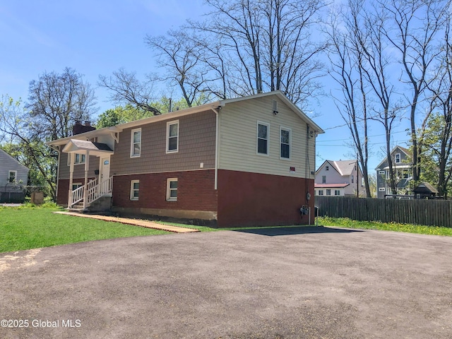 view of side of home with a lawn