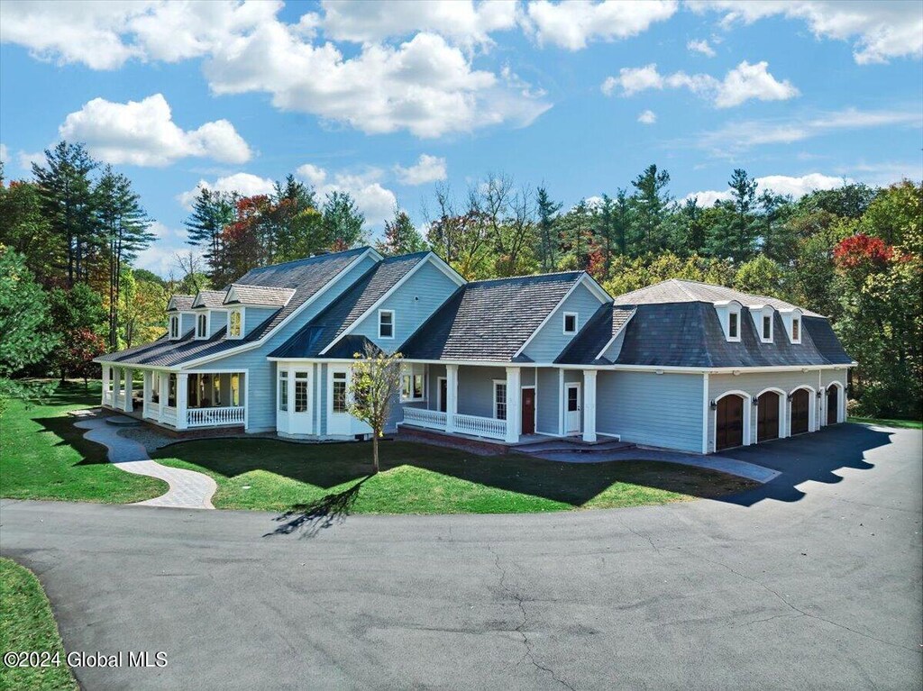 47 Talon Dr, New Scotland, NY 12159 - farmhouse with a front lawn, aphalt driveway, and covered porch