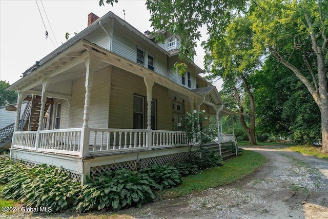 view of side of property with a porch