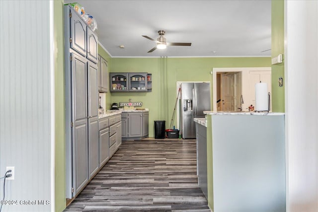 kitchen featuring white refrigerator, dark hardwood / wood-style floors, stainless steel fridge, ornamental molding, and washer / dryer