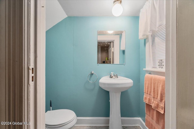 bathroom with vaulted ceiling and toilet