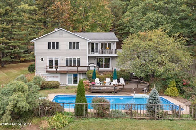 back of house featuring a balcony