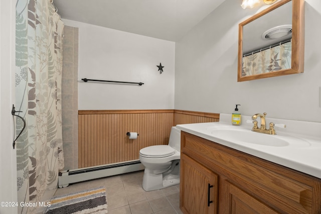 bathroom featuring toilet, baseboard heating, wooden walls, vanity, and tile patterned flooring