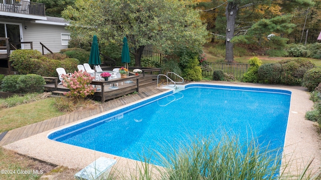 view of swimming pool with a deck