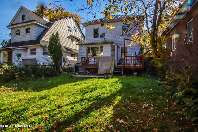 back of property featuring a yard and a deck