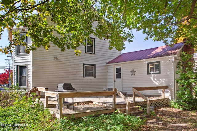 back of house with a wooden deck